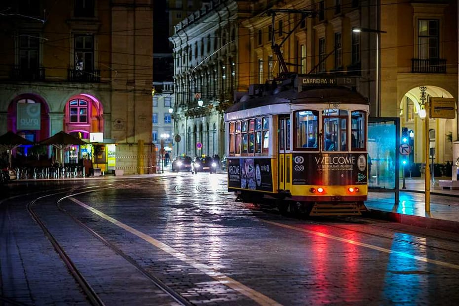 Lisbon travel guide for US retirees: A classic yellow tram in the Alfama district.